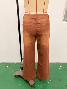 Detailed back view of vintage brown washed wide-leg denim jeans on a tailor mannequin stand