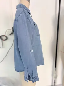 Side profile view of a casual blue denim long-sleeved shirt displayed on a mannequin.