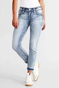 Detailed view of women's light wash slim-fit stretch denim jeans featuring embroidery
