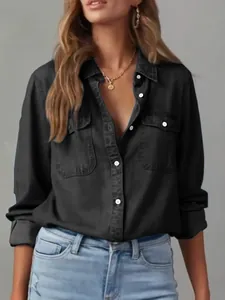 Detail view of the black denim long-sleeved shirt with single-breasted buttons.