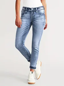 Detail view of women's slim fit stretch denim jeans with delicate star embroidery