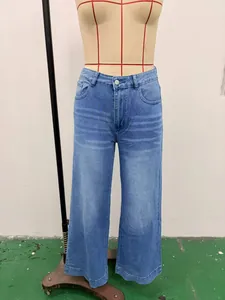 Detailed front view of washed blue high-waisted wide-leg denim jeans on a mannequin torso