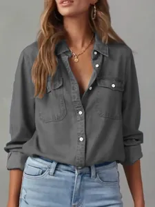Detailed macro view of a charcoal gray long-sleeve button-down denim shirt for women