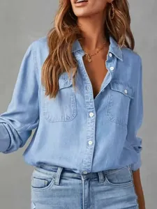 Detailed view of women's light blue lapel denim shirt with button-up front