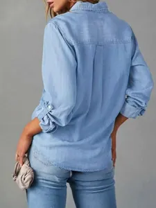 Back view of a casual light blue denim long-sleeved shirt showing collar and seam details