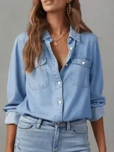 Close-up view of a casual women's long sleeve denim shirt with lapel and chest pockets