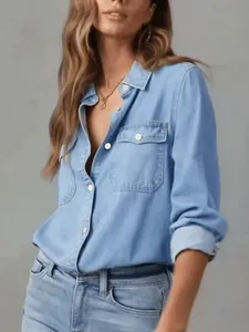 Close-up of a women's light blue long sleeve denim shirt with button-down collar