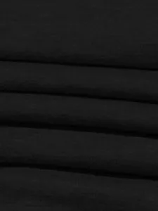 Close-up macro view of soft black knitted fabric texture for sports two-piece set
