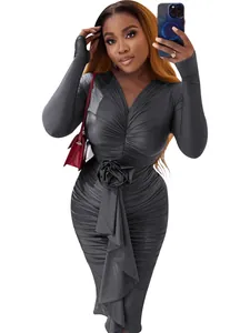 Detailed view of long-sleeved V-neck bodycon dress with ruched fabric and rose accent