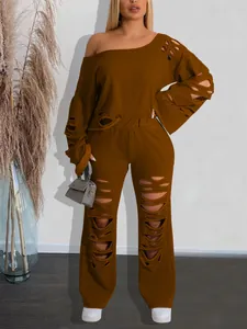 Detailed view of brown distressed two-piece set with off-shoulder top and ripped pants
