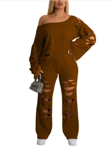 Close-up of distressed two-piece set with ripped sweatshirt and matching pants