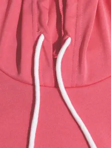 Close-up detail of a pink sporty hoodie showing the neckline and white drawstrings.