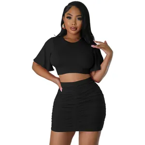 Detail shot of sexy black two-piece set with flutter sleeve top and ruched skirt.