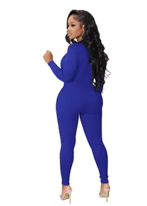 Back view of a form-fitting royal blue ribbed long-sleeve jumpsuit for women