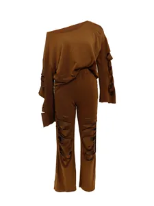 Detail of brown two-piece set featuring off-shoulder top and distressed ripped pants.