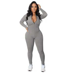 Detailed view of women's grey ribbed long sleeve jumpsuit with front zipper closure