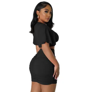 Sexy black two-piece set featuring short sleeve crop top and ruched bodycon mini skirt