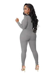 Back view of a grey ribbed zip-up jumpsuit showing slim fit athletic style