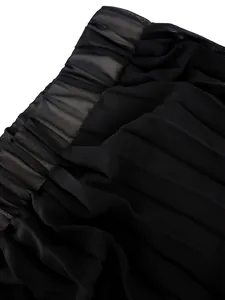 Macro detail shot of high-waist pleated wide-leg pants showing black chiffon fabric texture