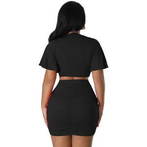Back view of a sexy black two-piece set featuring a short crop top and ruched bodycon skirt