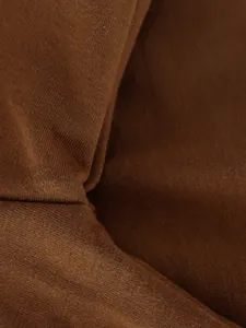 Macro view showing the soft texture and fine knit of the brown distressed sports set fabric.