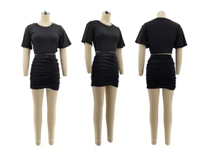Three-view display of black crop top and ruched skirt set on mannequins showing angles.