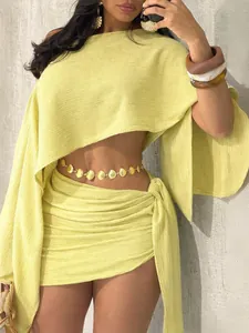 Close-up of lime green resort style one-shoulder top and ruched mini skirt set