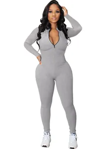 Full length view of a grey ribbed long-sleeve jumpsuit with a front zipper closure.