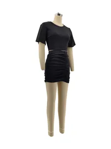 Full detail of a stylish black two-piece set including a crop top and ruched mini skirt