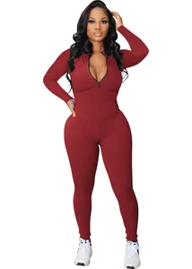 Full view of a burgundy ribbed long sleeve sport jumpsuit with a front zipper closure