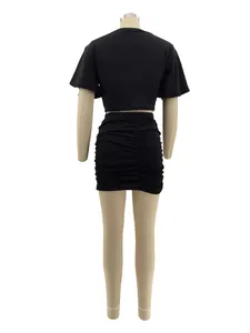 Back view of a black two-piece set featuring a crop top and ruched mini skirt