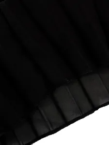 Detailed close-up showing the fine texture and edge stitching of black pleated fabric