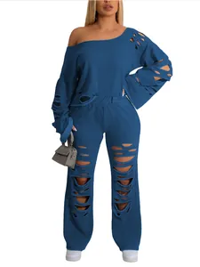 Detail view of a blue distressed two-piece lounge set with ripped off-shoulder top.