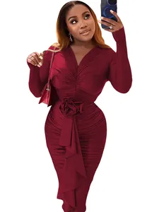 Detail view of elegant burgundy ruched long sleeve V-neck midi dress with waist rose