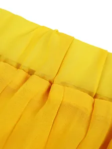 Detail view of yellow pleated fabric showing texture and drapery for summer wide leg pants.