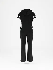 Back view of a women's black two-piece sports set featuring a hooded tee and striped pants