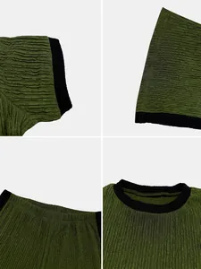 Detail view of green textured fabric and black trim on women's cropped top and pants set