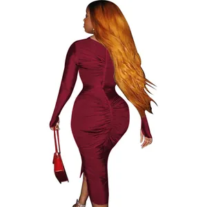 Detail view of burgundy ruched bodycon maxi dress with long sleeves and back slit