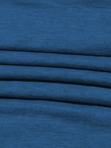 Macro view of premium blue knit fabric texture for comfortable sports sweatshirt and pants set.