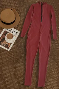 Full view of burgundy ribbed long sleeve sports jumpsuit with front zipper detail