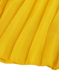 Close-up showing the fine texture and hem of these yellow pleated summer vacation trousers