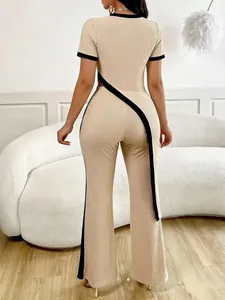Back view of beige ribbed two-piece set with black asymmetrical cut-out detail and wide-leg pants