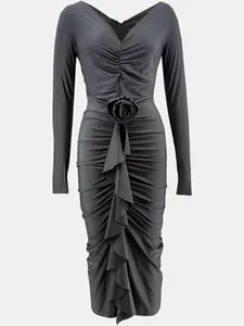 Front view of black long-sleeved V-neck midi dress featuring elegant rose waist detail.