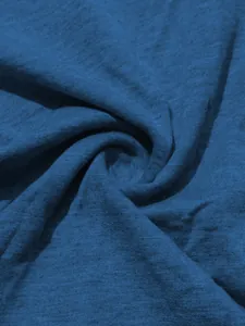 Close-up of blue knitted fabric texture showing soft jersey material for sports set.