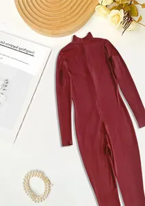 Detailed view of the burgundy ribbed knit fabric texture on an athletic jumpsuit