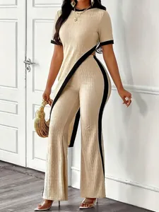 Detailed view of women's beige ribbed two-piece set with asymmetric top and wide-leg pants