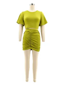 Detailed view of lime green two-piece set featuring a crop top and ruched mini skirt.