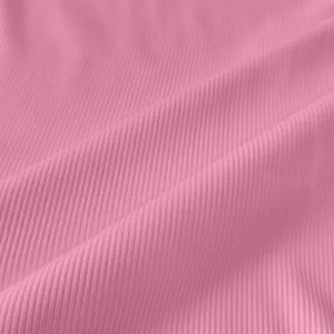 Macro detail of pink ribbed knit fabric showing vertical texture and soft folds.