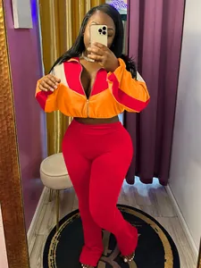 Women's two-piece color-block sports tracksuit set with zip-up jacket and red leggings.