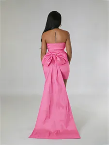 Elegant pink strapless tube mini dress featuring oversized bow and dramatic long train